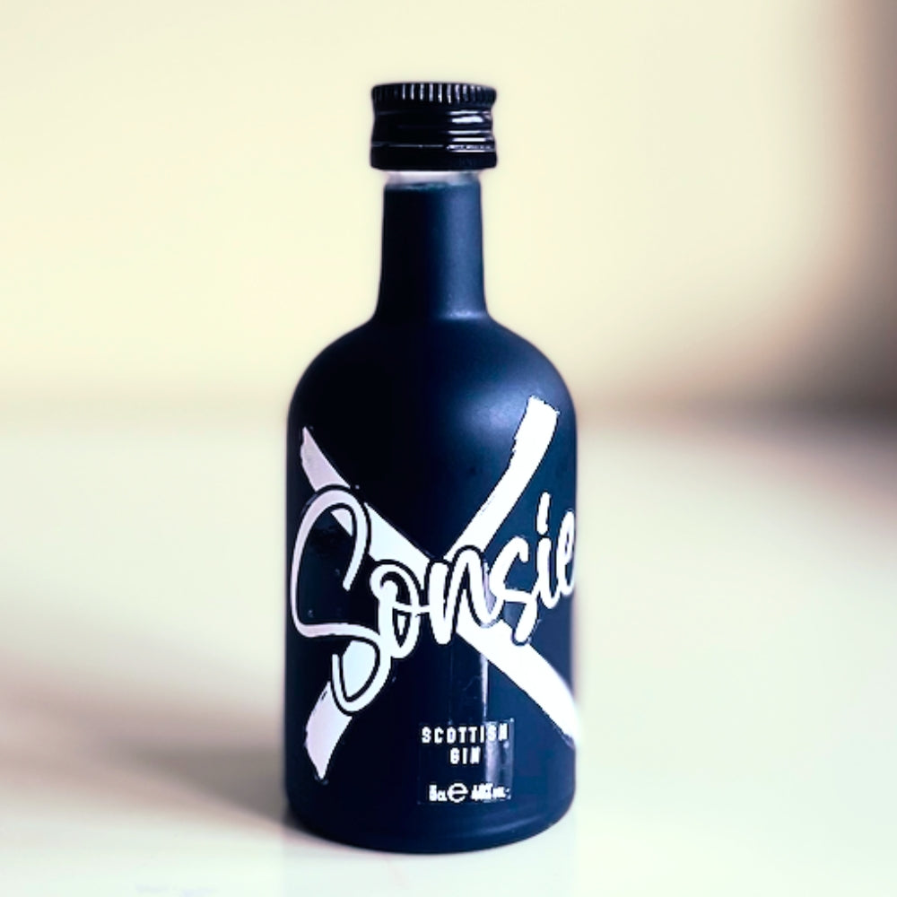 Miniature, dark blue matte bottle of 'Sonsie' Scottish gin.